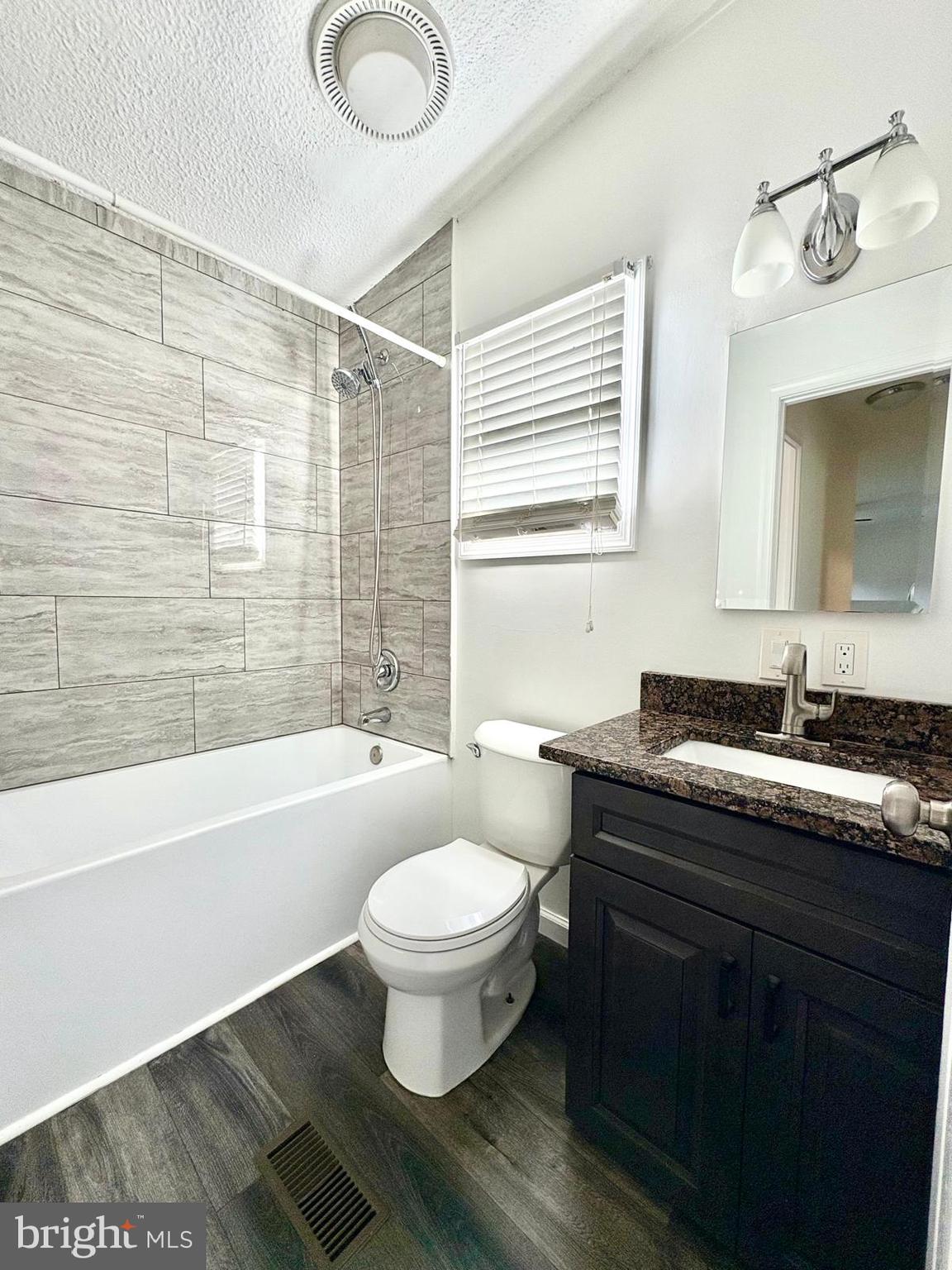 7714 Walnut Lane Mount Airy, MD 21771 - Photo 21 of 42 a bathroom with a sink toilet a mirror and bathtub
