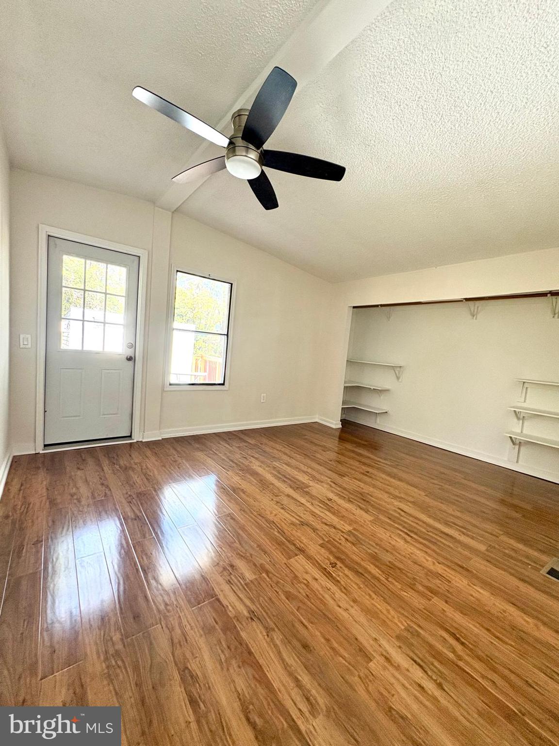 7714 Walnut Lane Mount Airy, MD 21771 - Photo 23 of 42 a view of empty room with wooden floor and fan