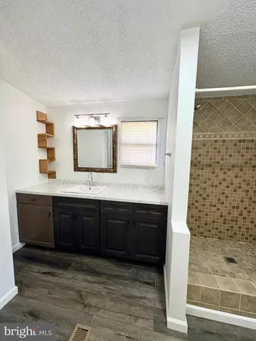 a bathroom with a double vanity sink and mirror