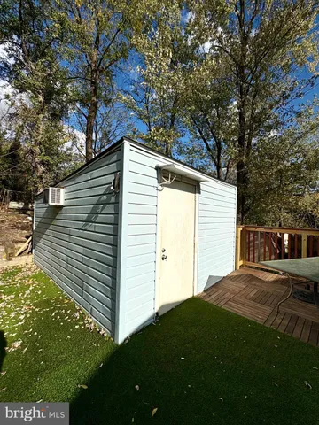 a view of backyard with barbeque grill and wooden fence