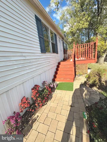 a view of a pathway with a flower garden