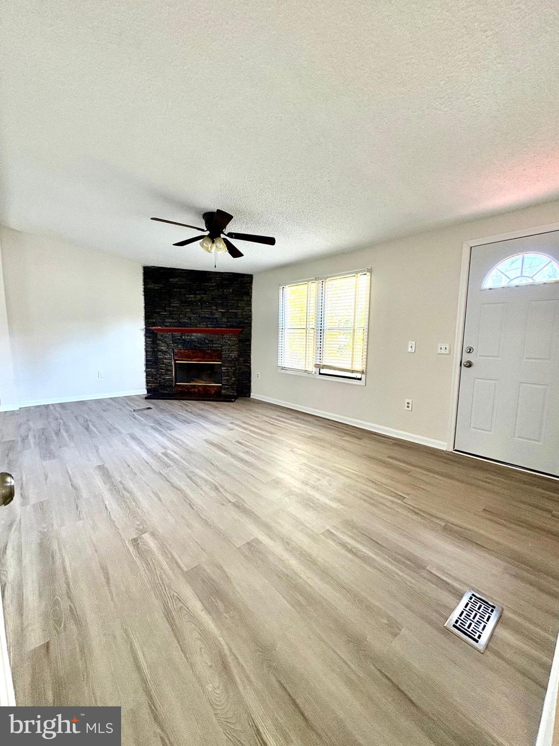 7714 Walnut Lane Mount Airy, MD 21771 - Photo 7 of 42 an empty room with windows and fireplace