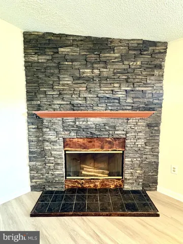 a view of fireplace and wooden floor