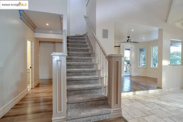 a kitchen with white cabinets and sink