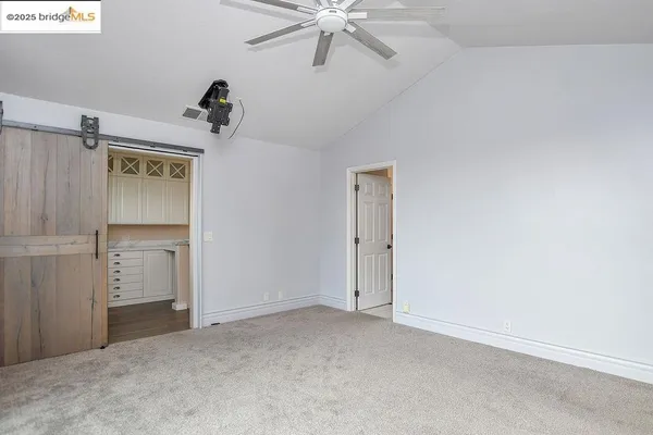 an empty room with windows and closet
