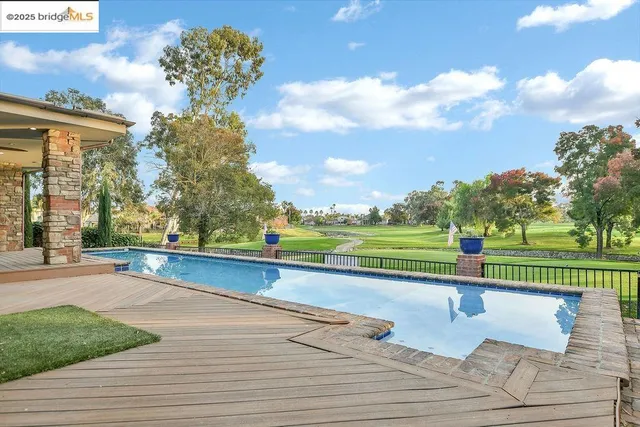 a swimming pool with outdoor seating and yard
