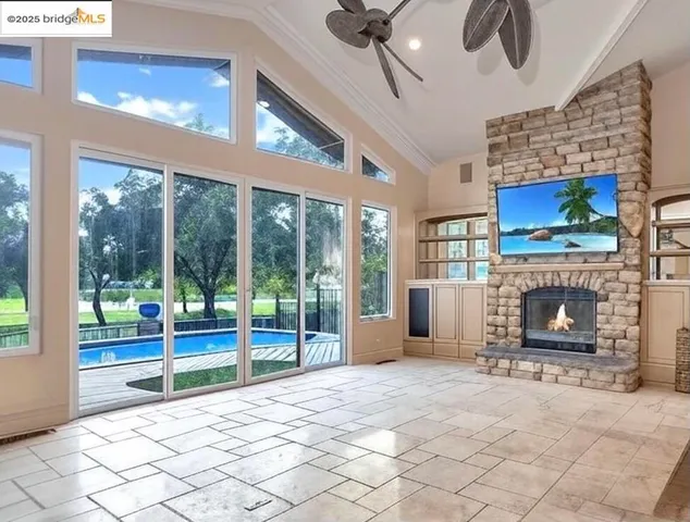 a living room with stainless steel appliances kitchen island granite countertop furniture wooden floor and a kitchen view