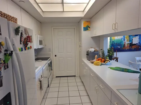 a kitchen with a sink a refrigerator and a stove