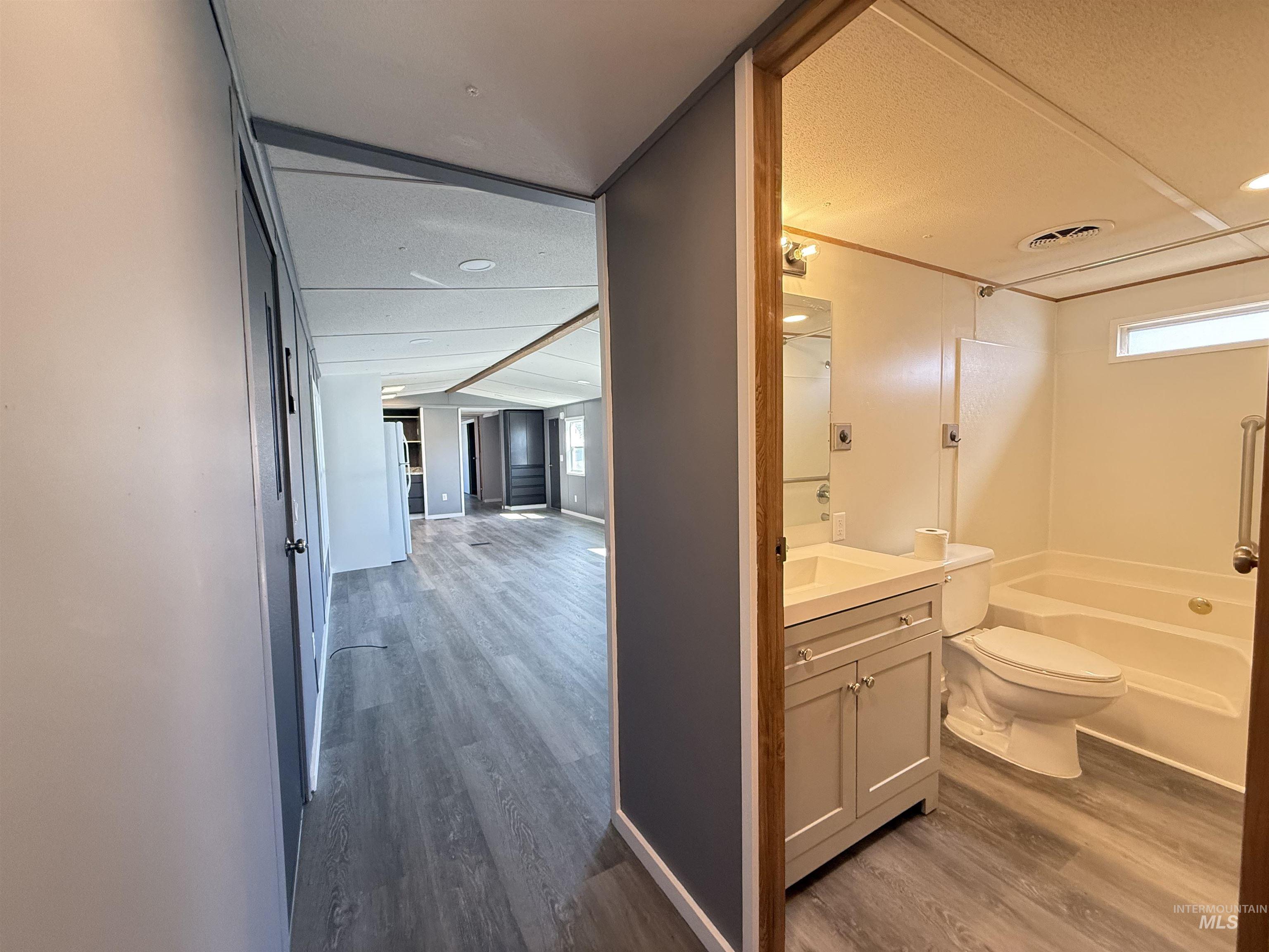 2015 6th Avenue, Unit 321 Clarkston, WA 99403 - Photo 13 of 34 Full bath featuring vanity, dark wood-type flooring, shower / bathtub combination, and a textured ceiling