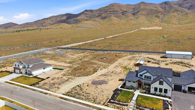 2930 Jojo Road, Unit 110 Eagle Mountain, UT 84005 - Photo 8 of 22 Aerial view of sparsely populated area featuring a mountainous background