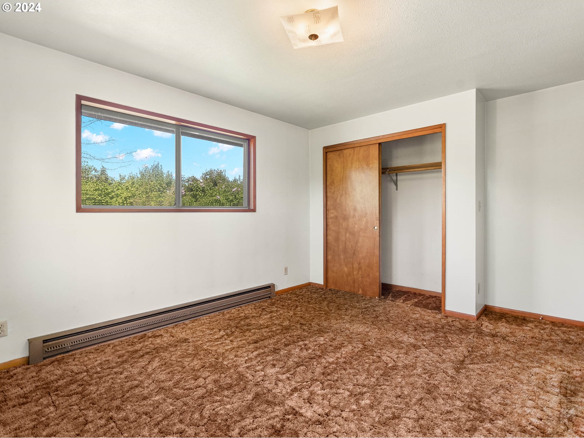 23865 Southwest Tile Flat Road Hillsboro, OR 97123 - Photo 17 of 36 a view of an empty room with window and closet