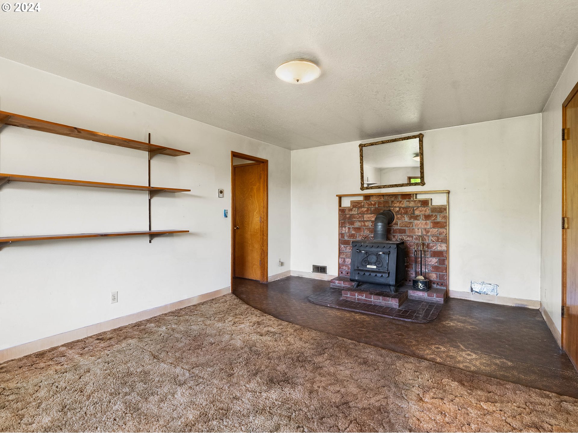 23865 Southwest Tile Flat Road Hillsboro, OR 97123 - Photo 23 of 36 a view of an empty room with a fireplace