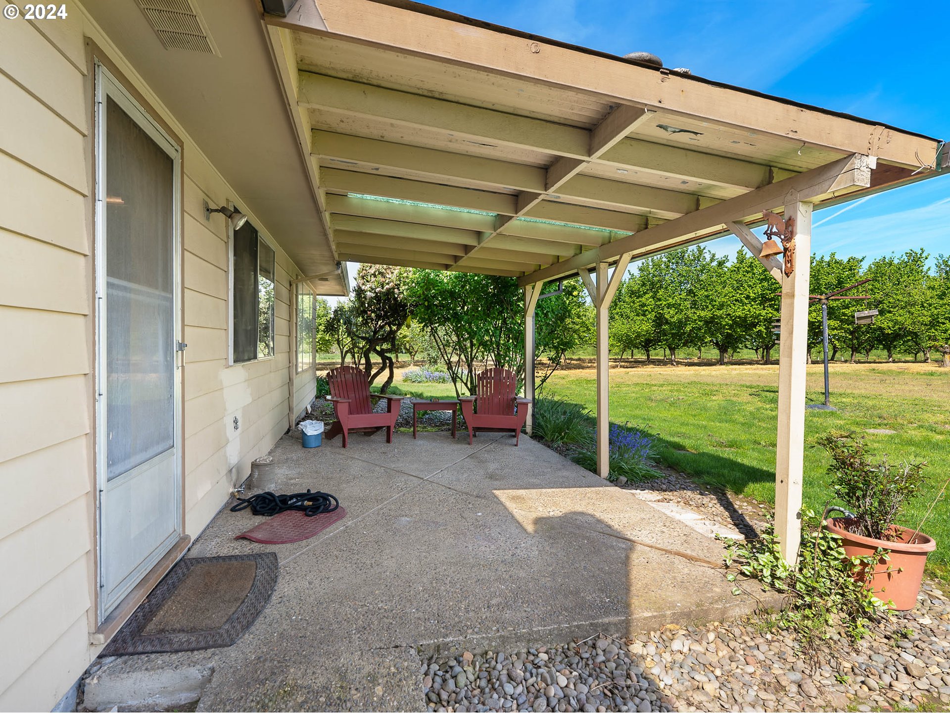 23865 Southwest Tile Flat Road Hillsboro, OR 97123 - Photo 25 of 36 a view of a patio with table and chairs under an umbrella
