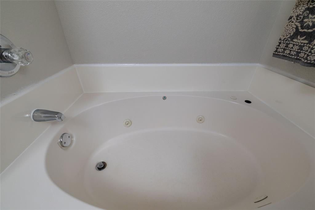 4025 Chisos Rim Trail Fort Worth, TX 76244 - Photo 25 of 40 Corner jetted bathtub featuring chrome fixtures and integrated controls