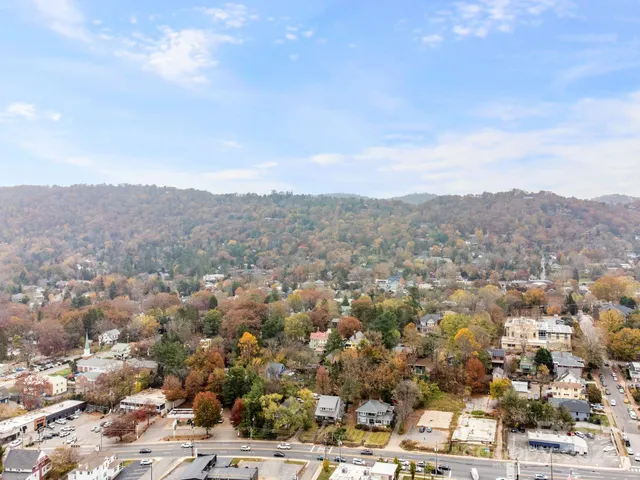 an aerial view of residential houses with outdoor space