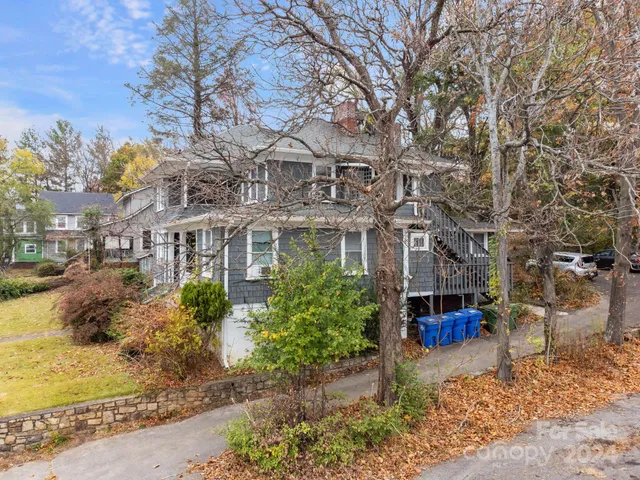 a front view of a building with a garden