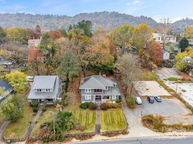 an aerial view of a house with a mountain