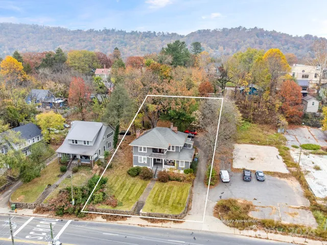 an aerial view of a house with a mountain