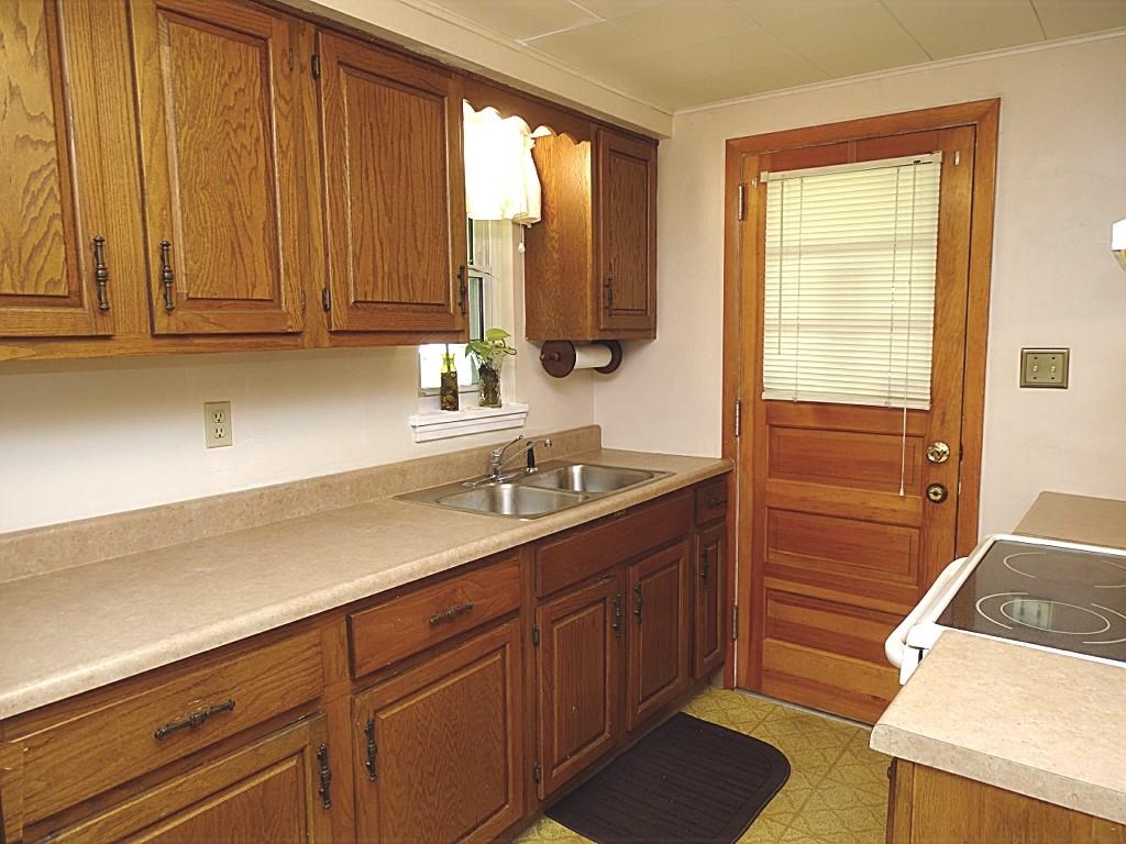 394 Rockhill Road Pittsburgh, PA 15243 - Photo 11 of 25 Galley kitchen with great storage, counterspace, door to deck (12x8)