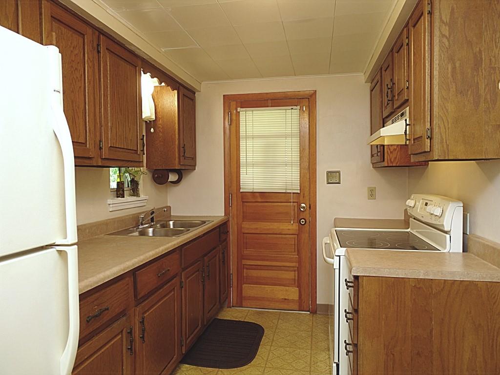 394 Rockhill Road Pittsburgh, PA 15243 - Photo 12 of 25 Galley kitchen with great storage, counterspace, door to deck (12x8)
