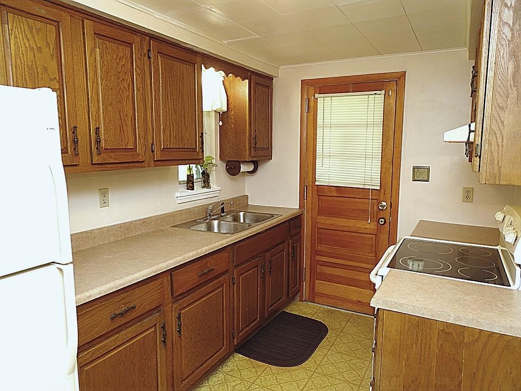 394 Rockhill Road Pittsburgh, PA 15243 - Photo 9 of 25 Galley kitchen with great storage, counterspace, door to deck (12x8)