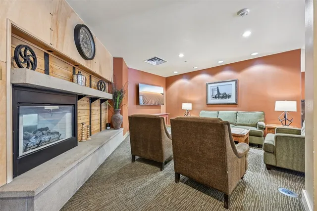 a living room with furniture a window and a fireplace