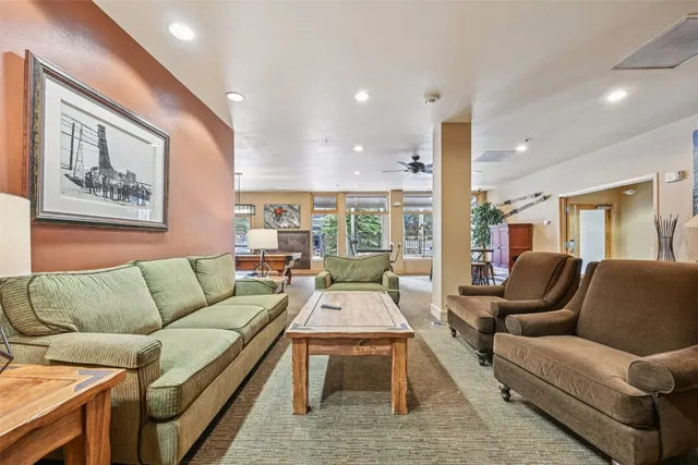a living room with furniture fireplace and a large window