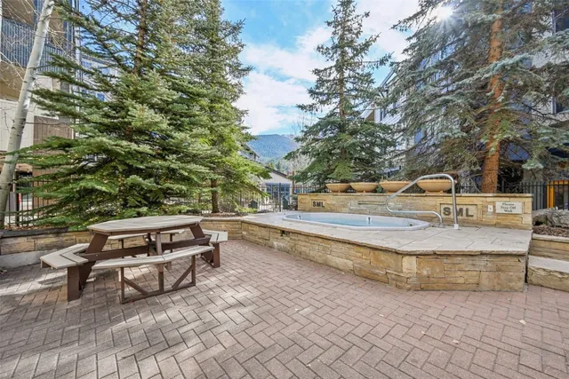 a swimming pool with outdoor seating and yard