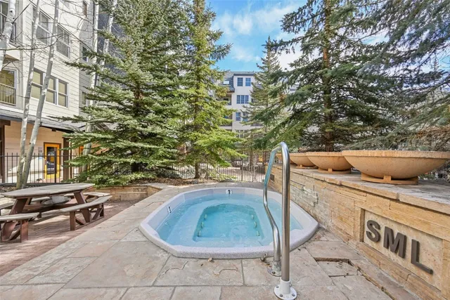 a view of a chairs and table in the patio in front of buildings