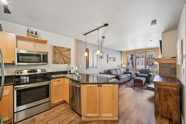 a kitchen with stove a sink and refrigerator