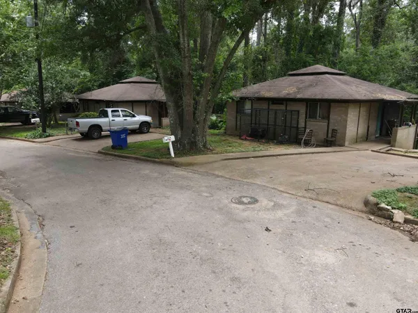 a view of a blue and a table and chairs under an umbrella