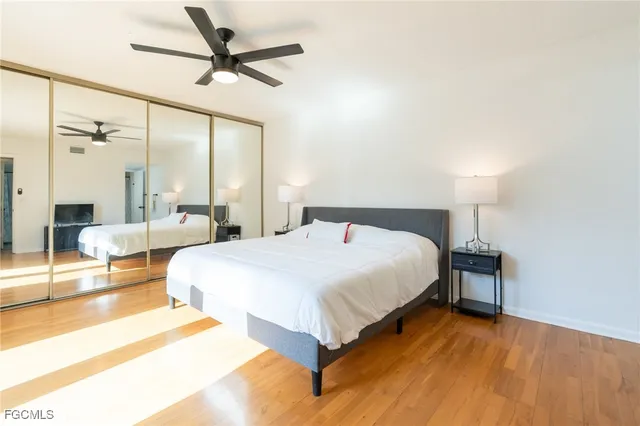 a spacious bedroom with a bed and a chandelier