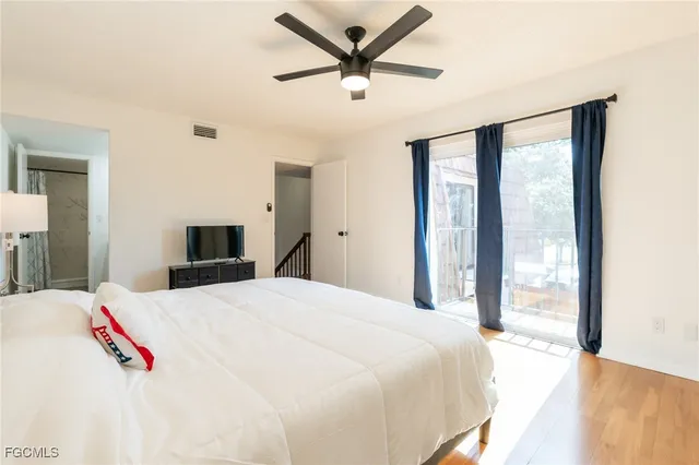 a bedroom with a bed and a large window