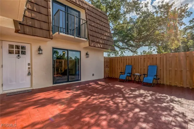 a view of a house with backyard and sitting area