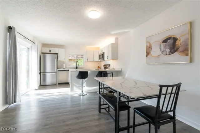 a view of a dining room with furniture and a kitchen