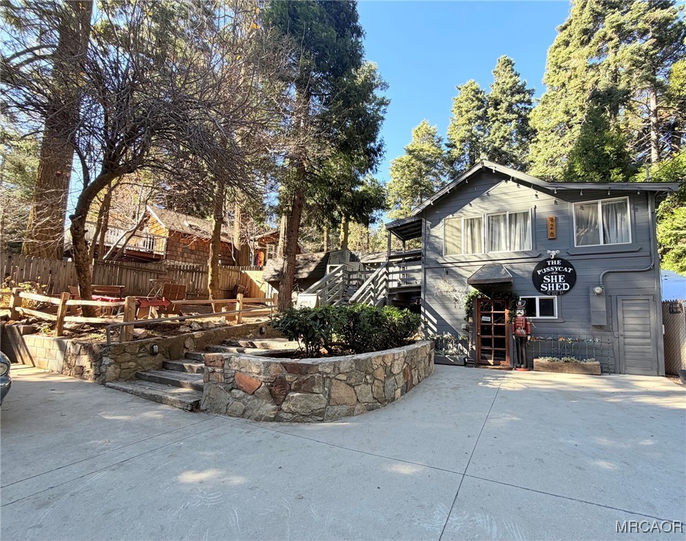 926 Kuffle Canyon Road Skyforest, CA 92385 - Photo 1 of 35 a view of a house with a cars park side of a road