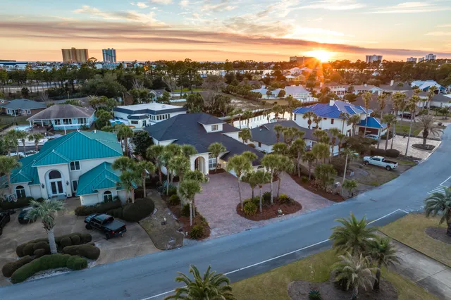a living room with furniture a flat screen tv and a floor to ceiling window