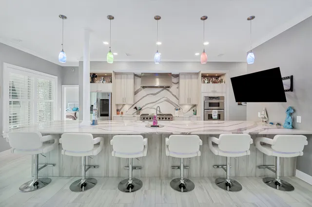 a view of a hallway with wooden floor and a chandelier
