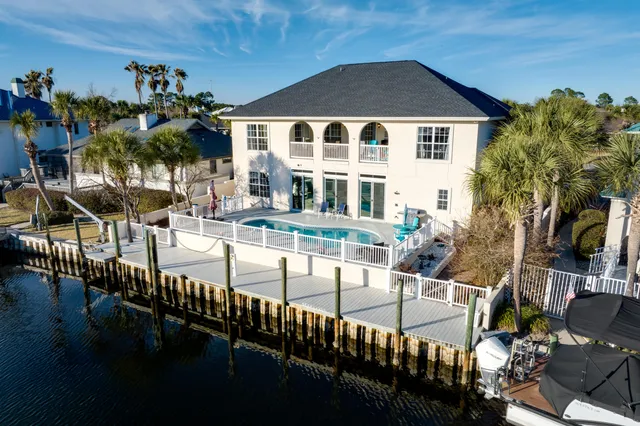 a view of a dining room with furniture and a chandelier