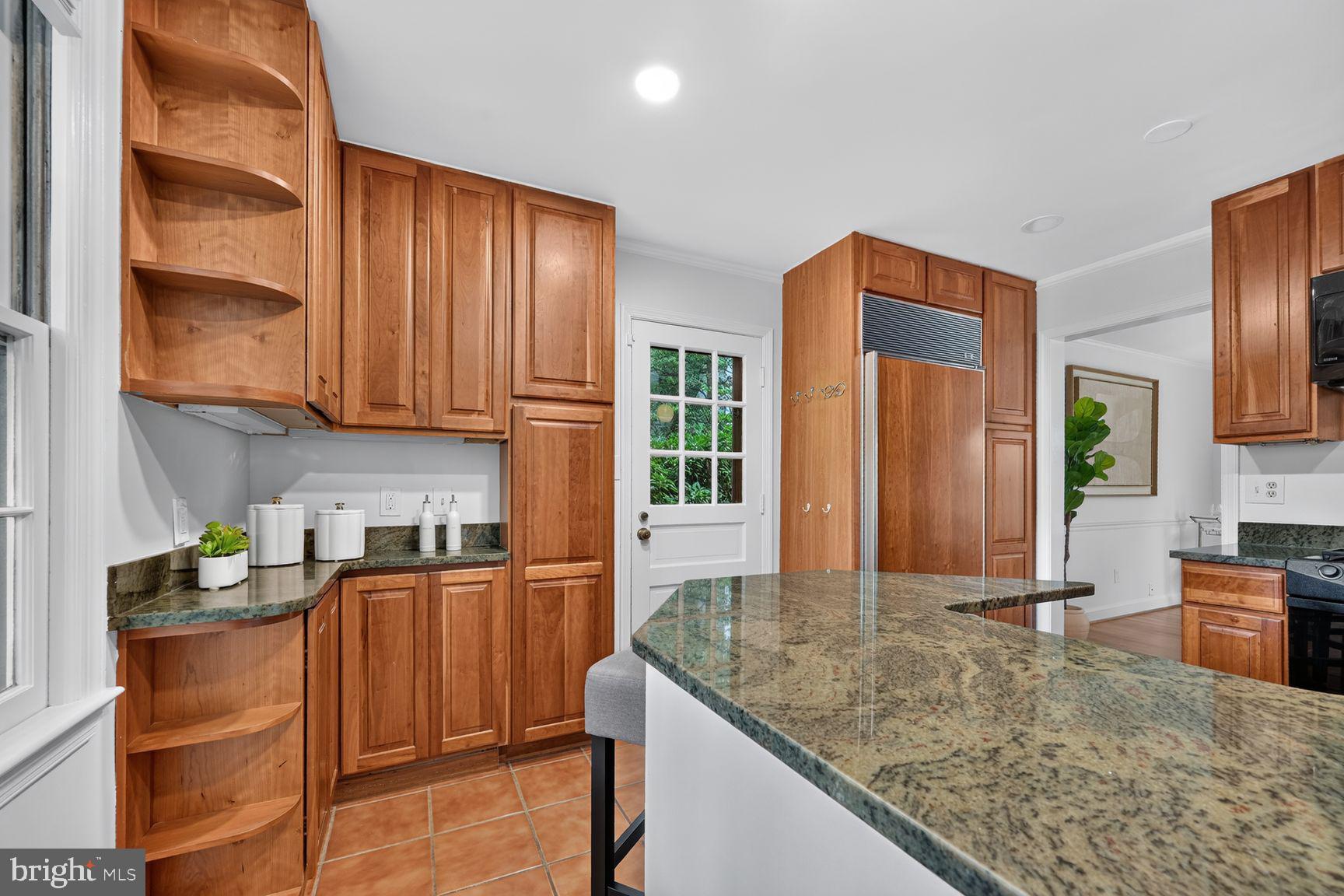 4605 Reno Road Northwest Washington, DC 20008 - Photo 14 of 49 a kitchen with stainless steel appliances granite countertop wooden cabinets a refrigerator and a sink