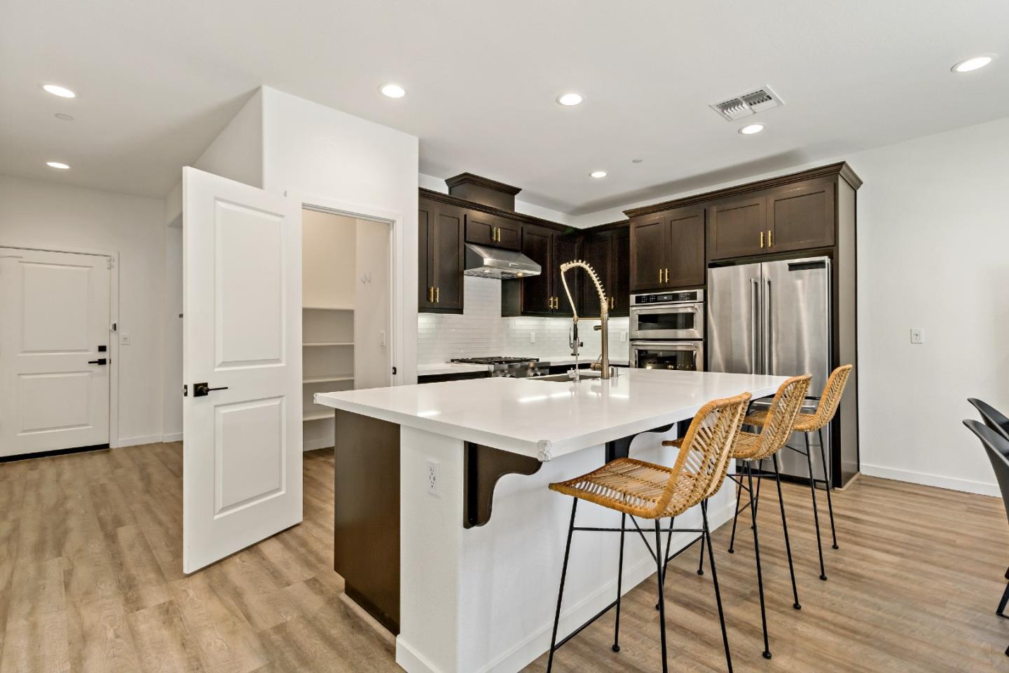113 Willowrun Way Oakley, CA 94561 - Photo 19 of 63 a kitchen with stainless steel appliances kitchen island a hardwood floor and chairs
