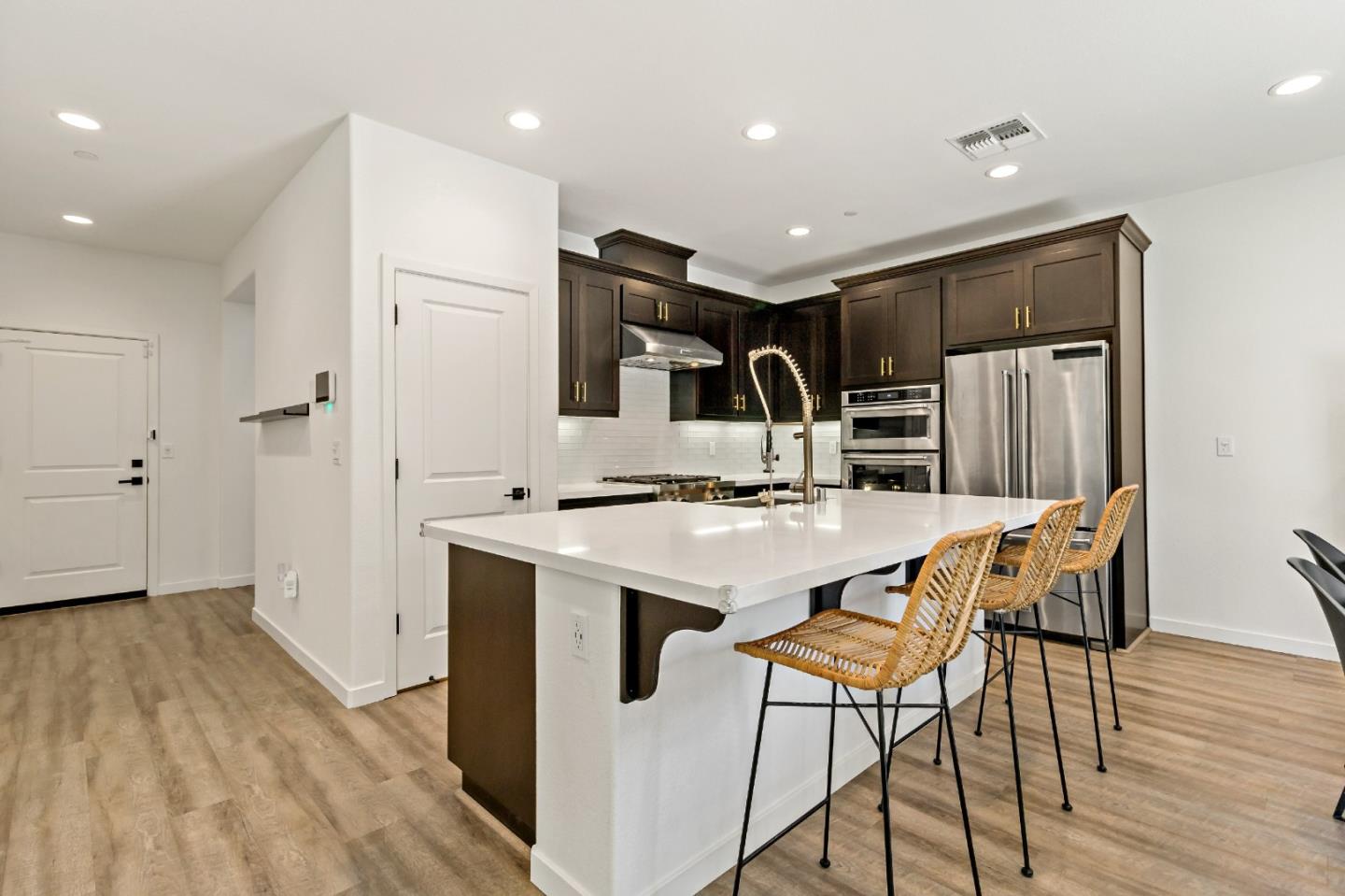 113 Willowrun Way Oakley, CA 94561 - Photo 20 of 63 a kitchen with stainless steel appliances kitchen island a hardwood floor and chairs