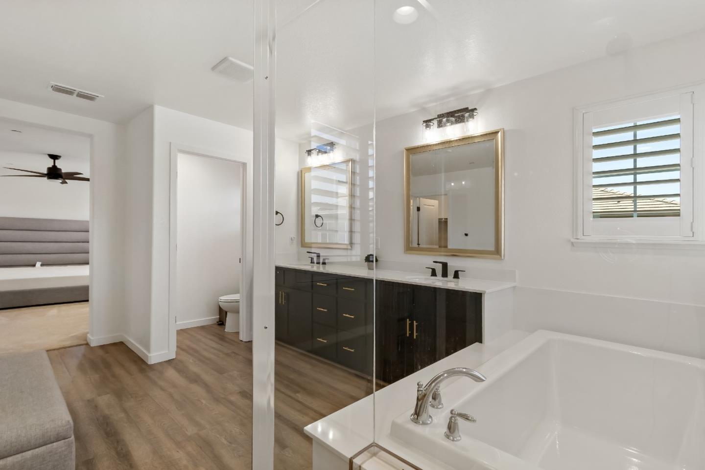 113 Willowrun Way Oakley, CA 94561 - Photo 40 of 63 a bathroom with a tub a double vanity sink and mirror