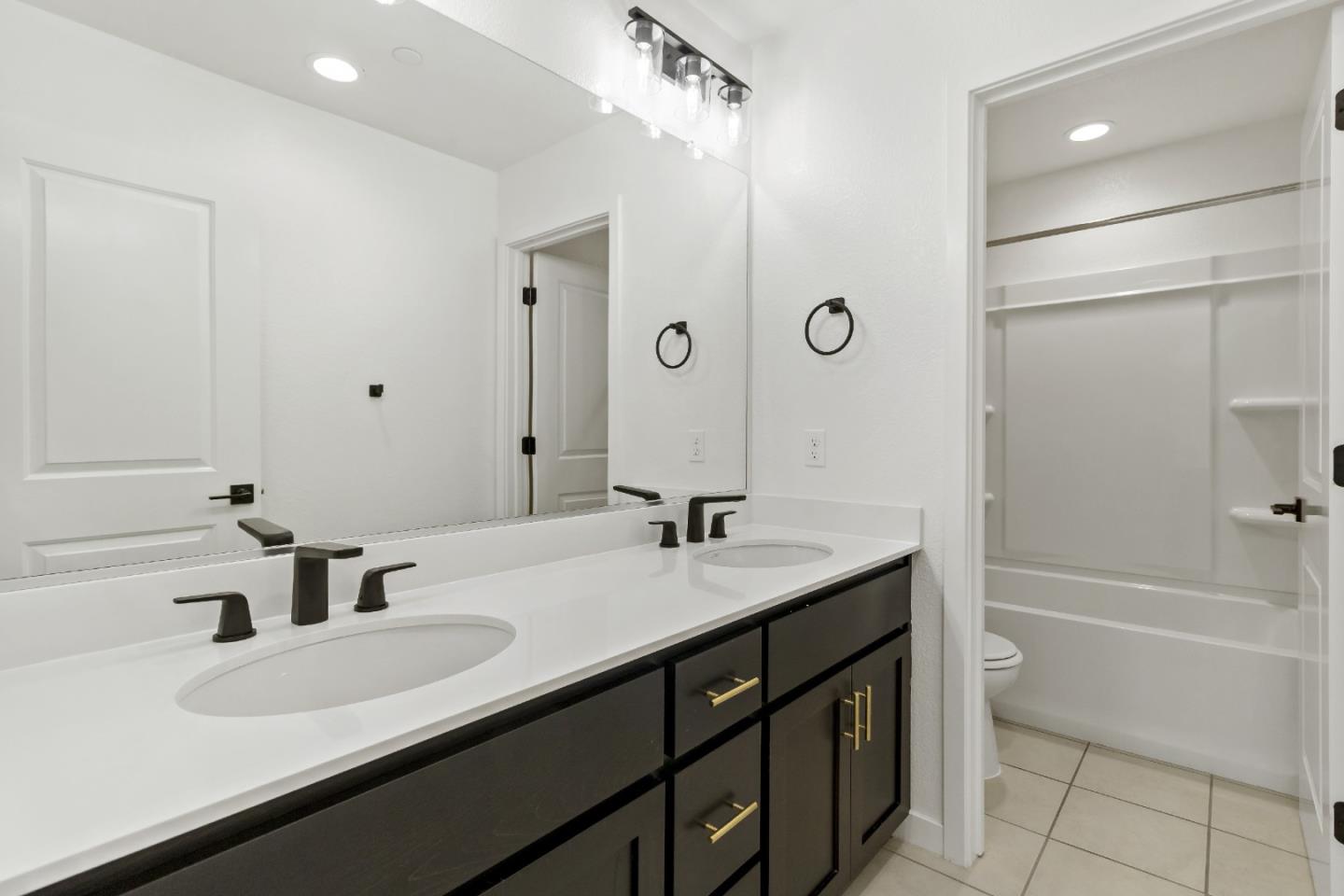 113 Willowrun Way Oakley, CA 94561 - Photo 45 of 63 a bathroom with a granite countertop sink and a mirror