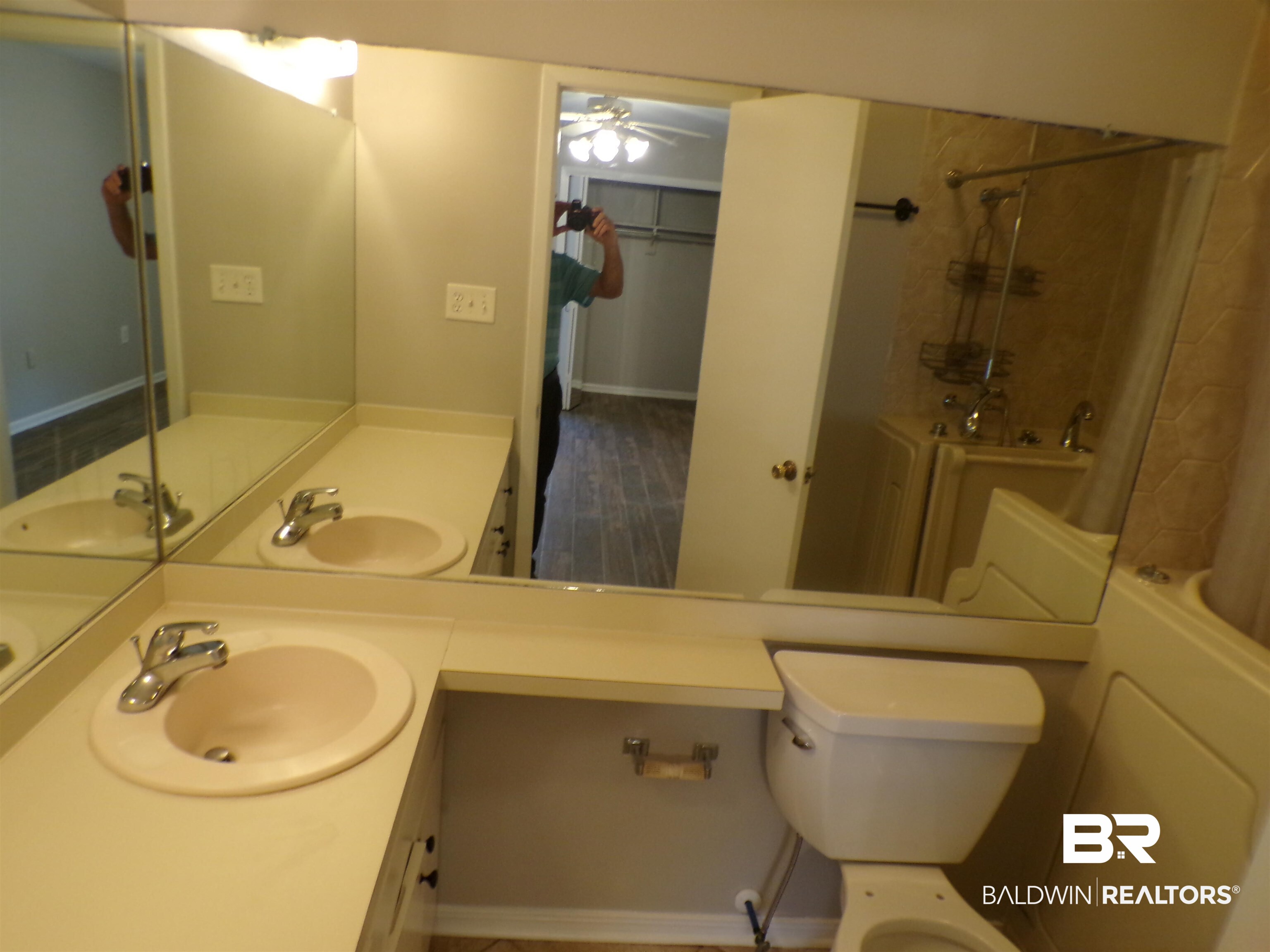 1152 North Alston Street, Unit 1152 Foley, AL 36535 - Photo 14 of 16 Bathroom featuring a double vanity with integrated sinks, chrome faucets, full-width mirror, and a toilet