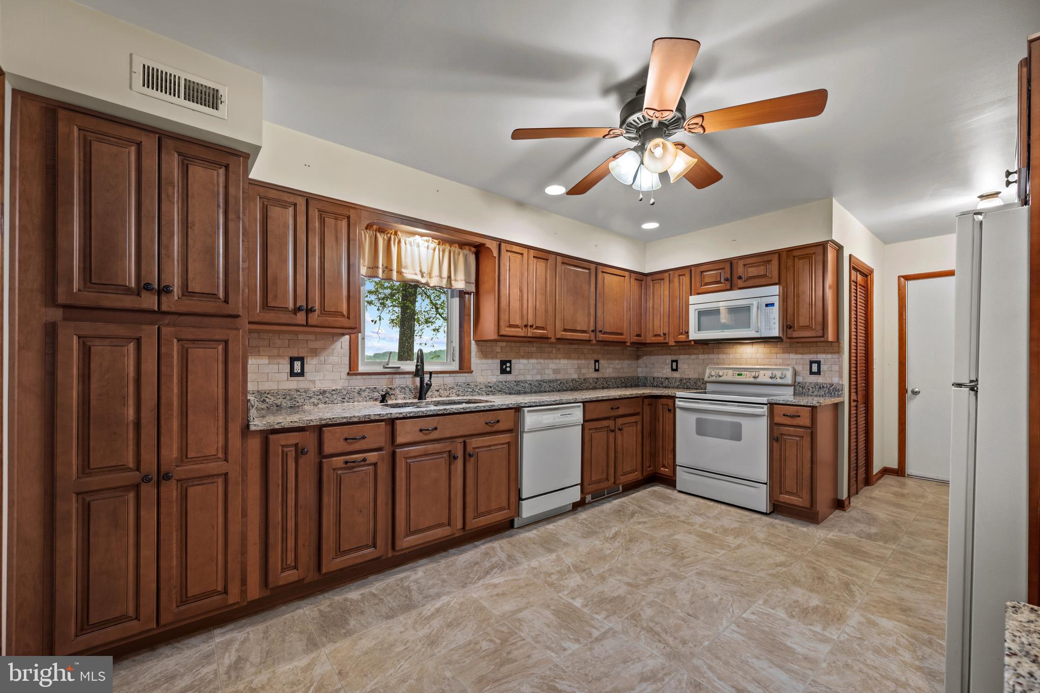 5313 Wentz Road Manchester, MD 21102 - Photo 36 of 51 a kitchen with stainless steel appliances granite countertop a stove refrigerator and cabinets