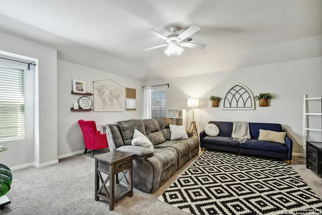 a living room with furniture and a rug