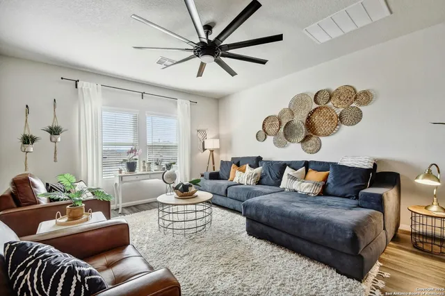 a living room with furniture and a large window