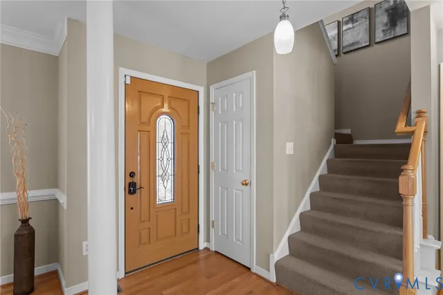 a view of a hallway with wooden floor and entryway