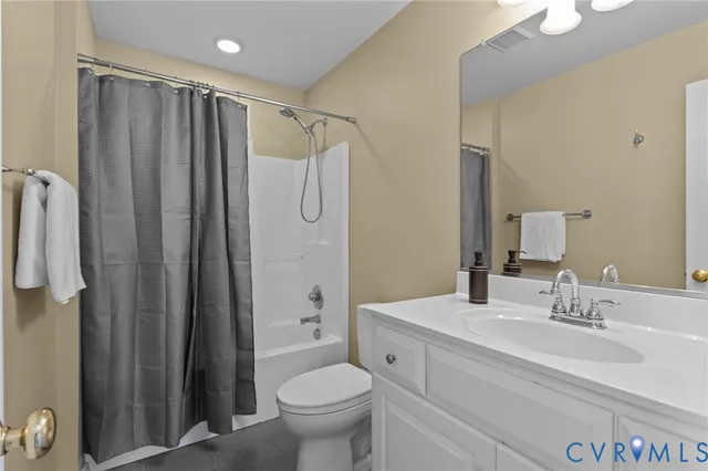 a bathroom with a sink toilet double vanity and shower